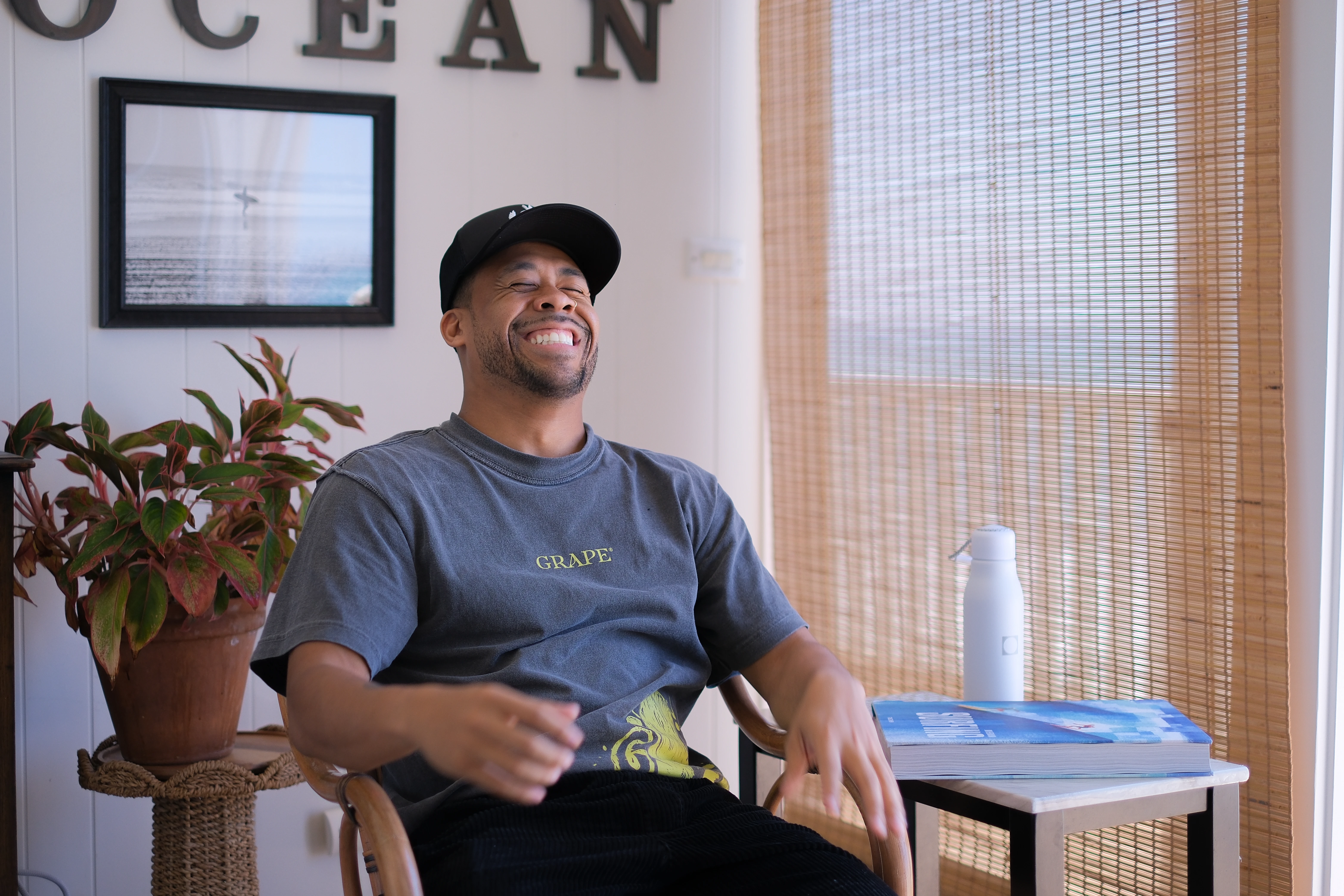 Chris Owens laughing in the chair on set