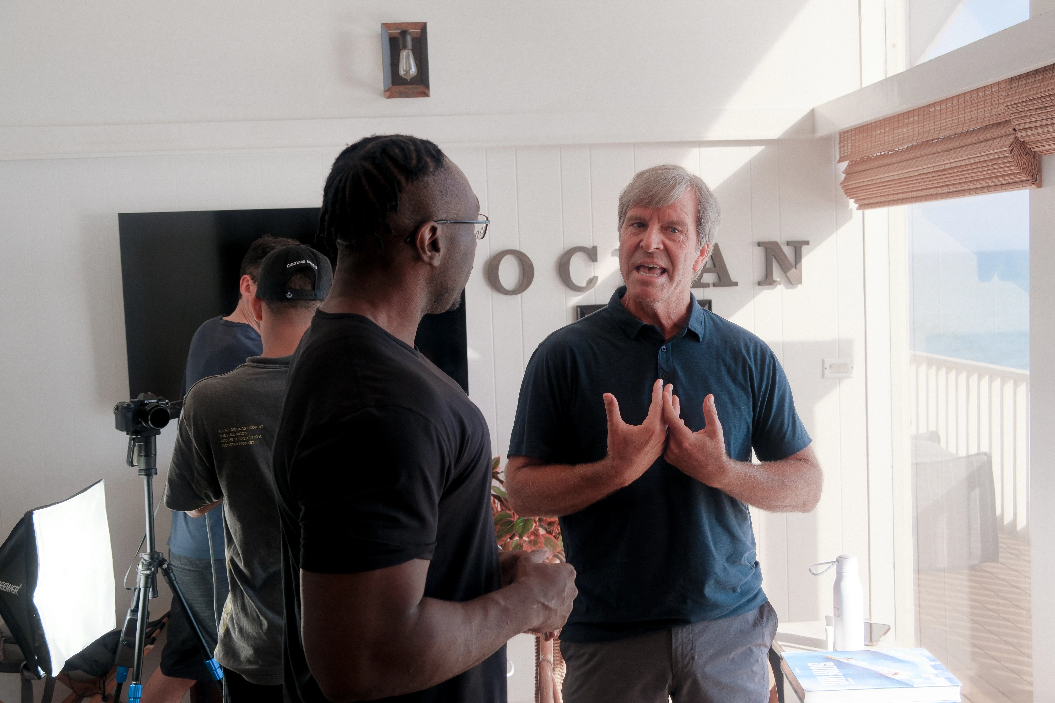 Dr. Kramer mid-thought, talking with Chima Odunze between takes
