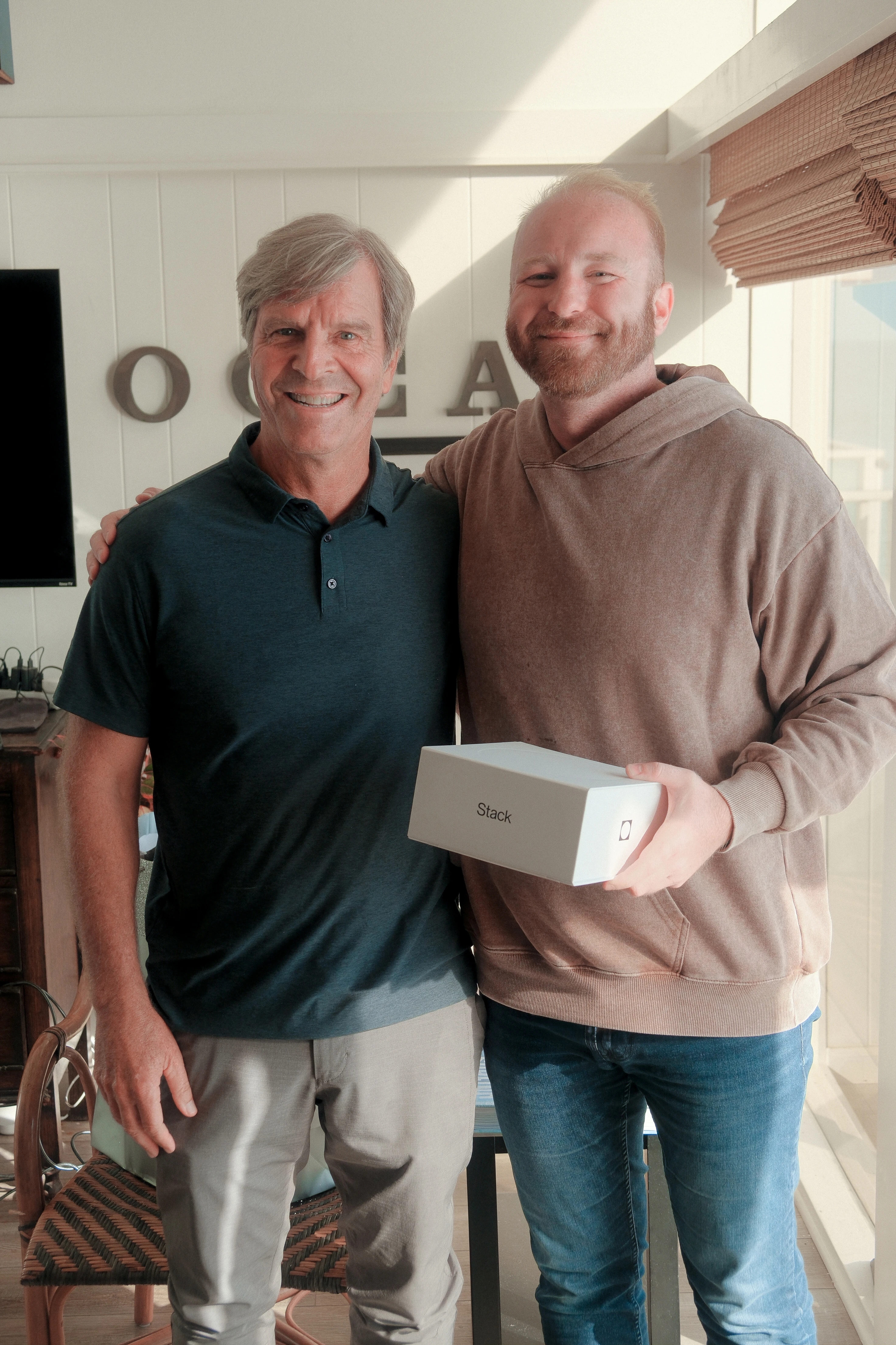 Dr. Kramer and Kirk Ouimet on set, holding a box of Stack