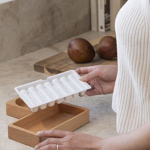 Man putting a capusle of Stack into his bag.